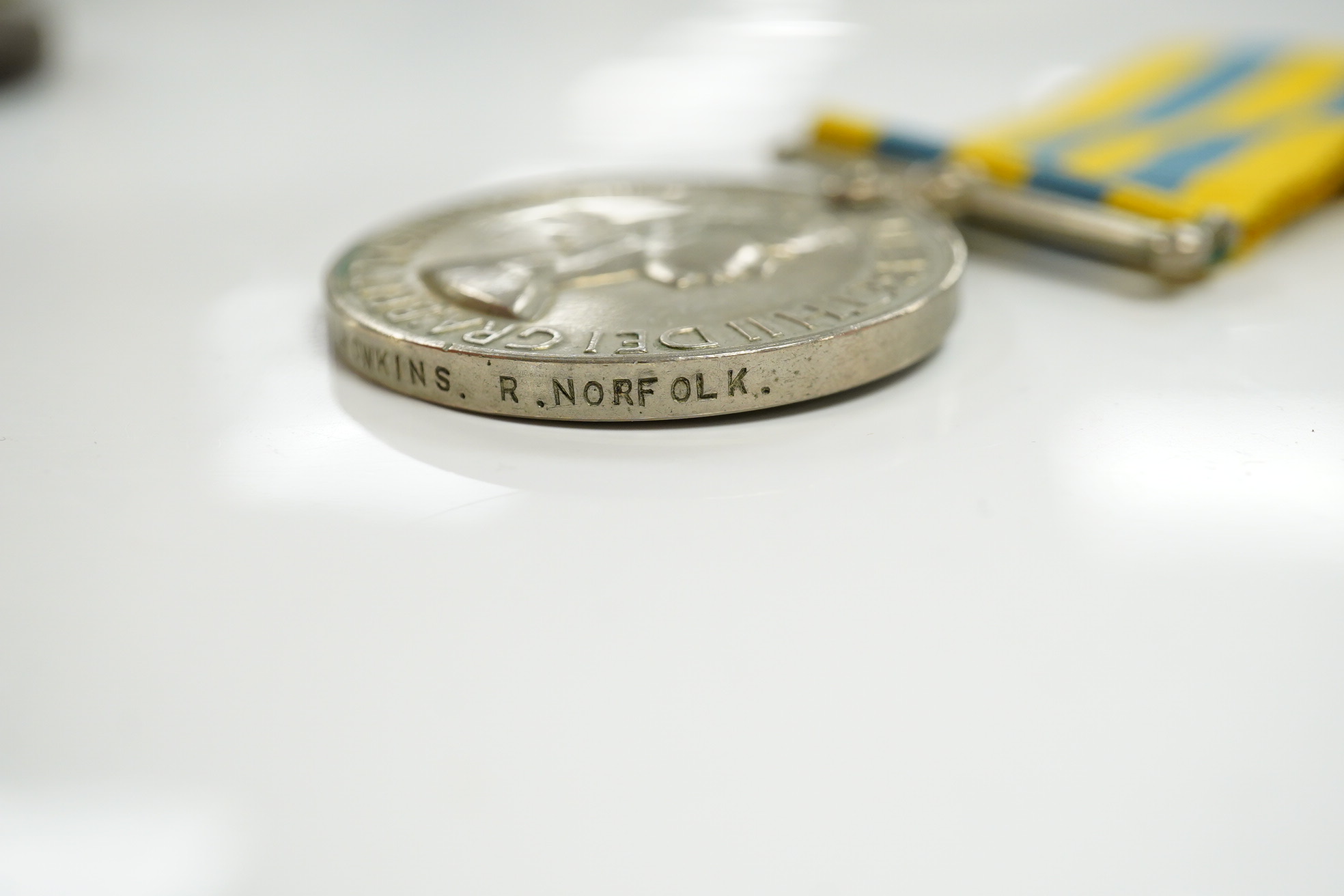 A First World War medal pair awarded to SJT. F.C. Howkins, The Queen’s R., together with a QEII Korea medal pair awarded to CPL. T.A. Howkins, R. Norfolk, plus a Lusitania propaganda medallion, all contained in a Princes